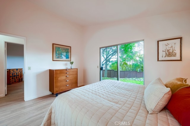 bedroom featuring access to exterior, light wood-style flooring, and baseboards