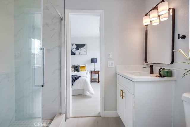 bathroom featuring toilet, ensuite bath, a marble finish shower, and vanity