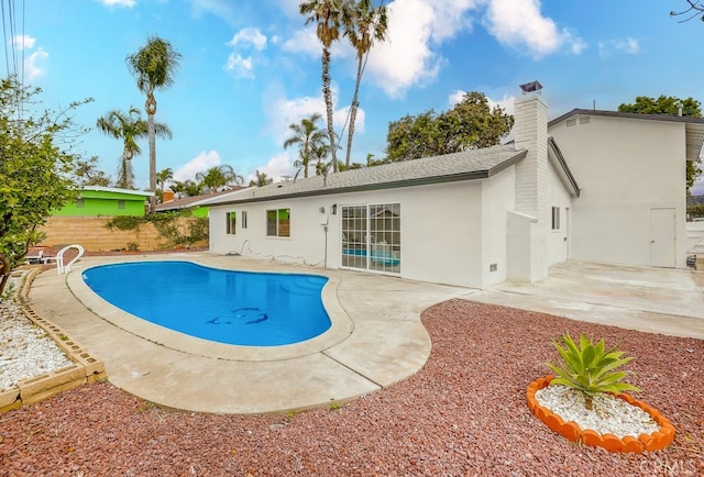 view of swimming pool with a patio area, fence, and a fenced in pool