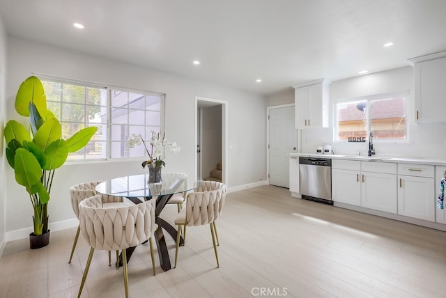 dining space with baseboards, light wood finished floors, stairway, and recessed lighting