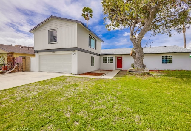 view of front of house featuring an attached garage, fence, concrete driveway, and a front yard