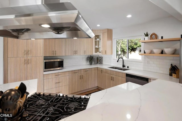 kitchen featuring dishwashing machine, stainless steel microwave, island exhaust hood, light brown cabinets, and a sink