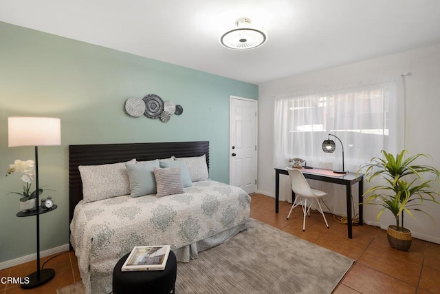 bedroom with tile patterned flooring and baseboards