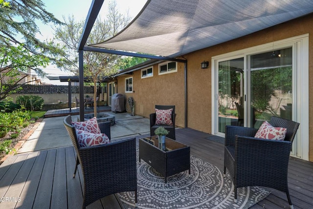 wooden terrace with fence and an outdoor living space