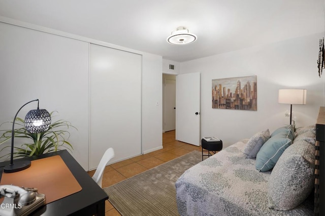 bedroom featuring a closet, tile patterned flooring, and visible vents