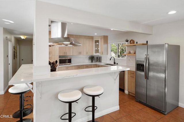 kitchen with light tile patterned floors, tasteful backsplash, appliances with stainless steel finishes, extractor fan, and light brown cabinets