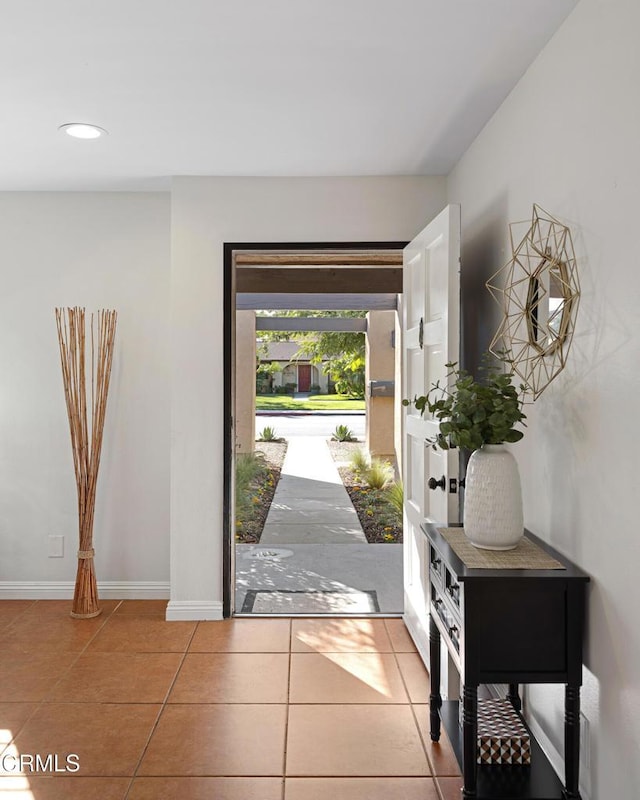 tiled entryway featuring baseboards and recessed lighting