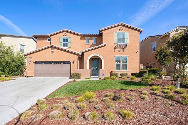 mediterranean / spanish-style home with driveway, a garage, a tiled roof, a gate, and stucco siding