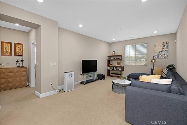 living area with baseboards, recessed lighting, and light colored carpet