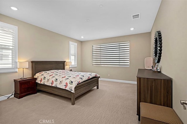 bedroom with recessed lighting, visible vents, light carpet, and baseboards