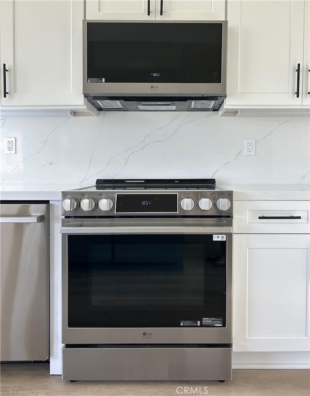 kitchen with white cabinets, stainless steel appliances, and light countertops