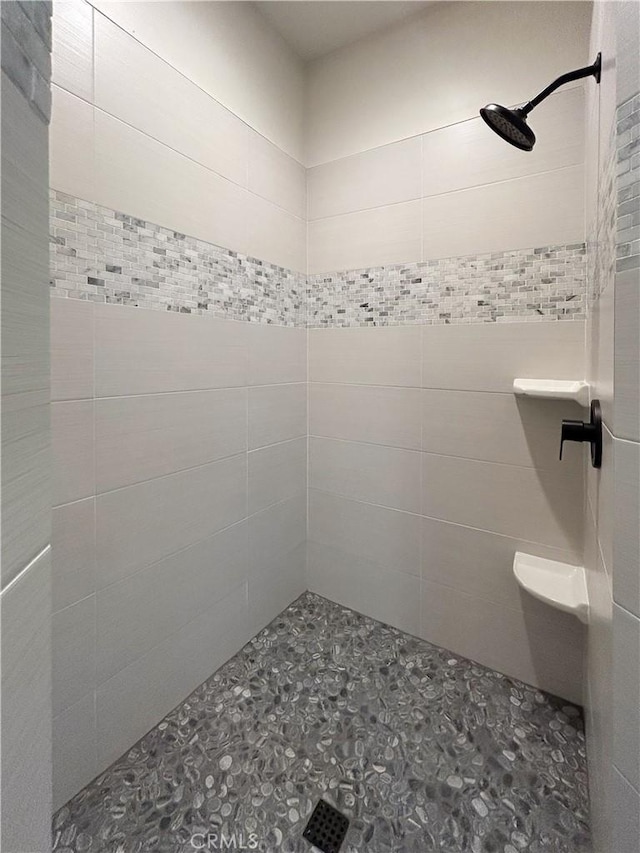 bathroom with tiled shower