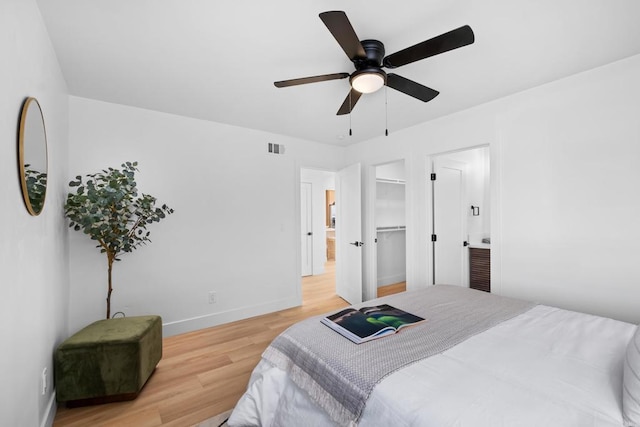 bedroom with baseboards, a ceiling fan, visible vents, and light wood-style floors