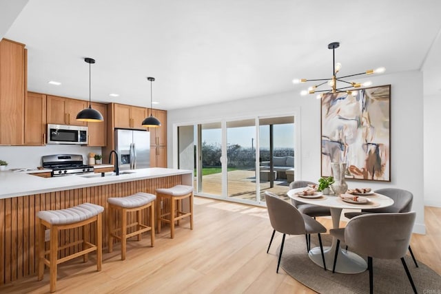 dining room featuring light wood-style flooring and an inviting chandelier