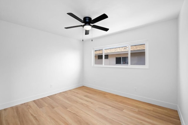 unfurnished room featuring ceiling fan, light wood finished floors, and baseboards