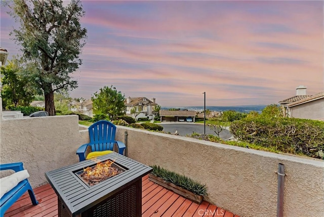 wooden deck featuring a fire pit