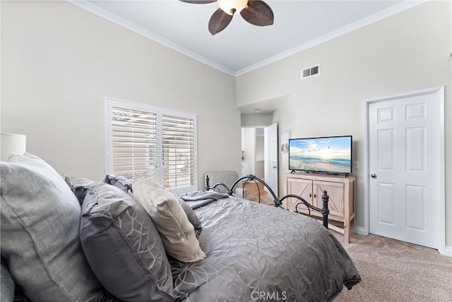 carpeted bedroom featuring baseboards, visible vents, a ceiling fan, and ornamental molding