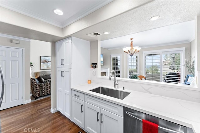 kitchen featuring dishwasher, ornamental molding, dark wood finished floors, and a sink