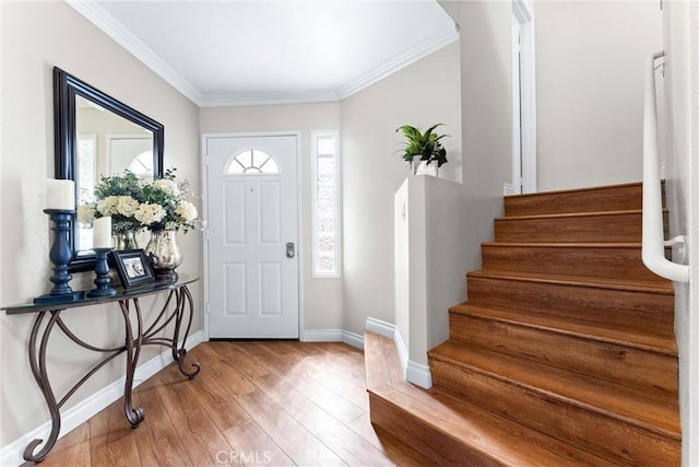 entrance foyer with hardwood / wood-style flooring, baseboards, stairway, and ornamental molding