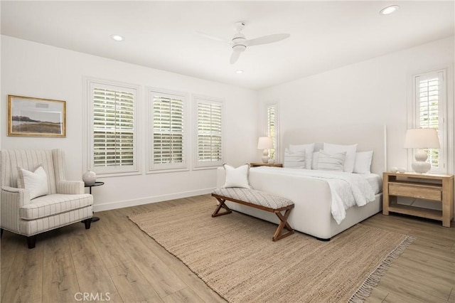 bedroom with baseboards, ceiling fan, wood finished floors, and recessed lighting