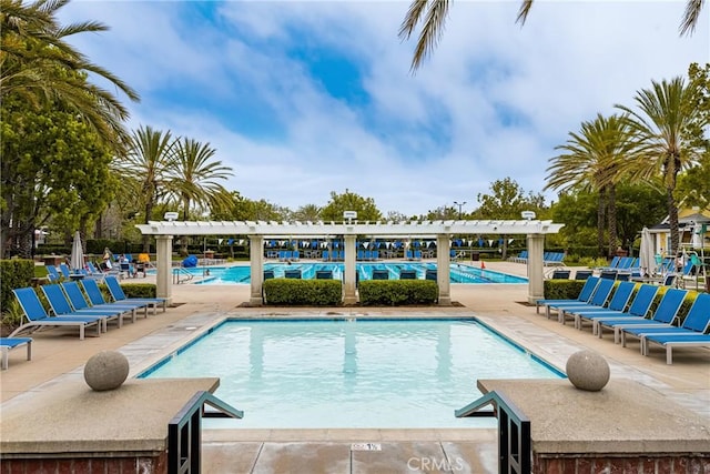 pool with a patio and a pergola