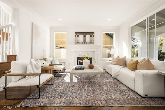 living area featuring recessed lighting, crown molding, and a premium fireplace