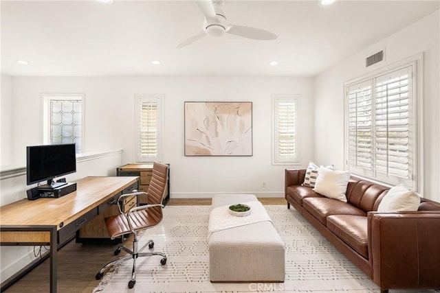 home office featuring light wood finished floors, visible vents, a ceiling fan, and recessed lighting