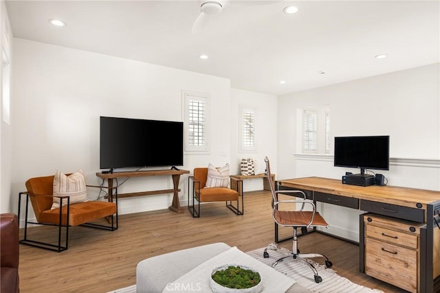 office space with baseboards, light wood-style flooring, and recessed lighting