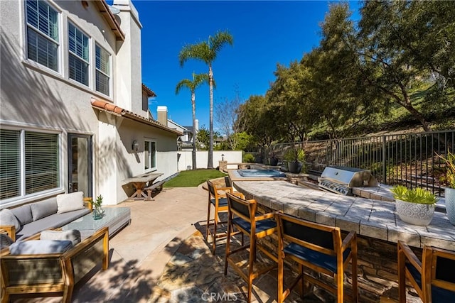 view of patio / terrace with a fenced backyard, area for grilling, an outdoor living space, outdoor dry bar, and grilling area