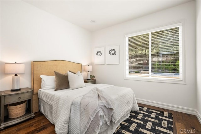 bedroom with baseboards and dark wood finished floors