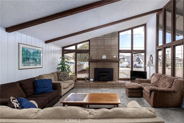 living area featuring carpet flooring, a textured ceiling, and lofted ceiling with beams