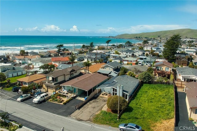 drone / aerial view with a water view and a residential view