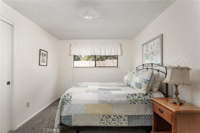 carpeted bedroom with a textured ceiling and baseboards