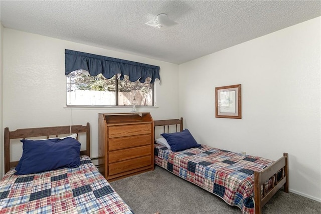 bedroom featuring carpet floors and a textured ceiling