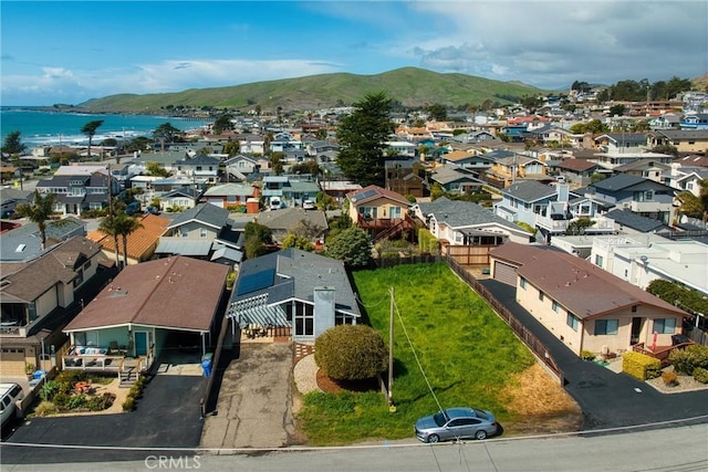 birds eye view of property with a residential view and a water and mountain view