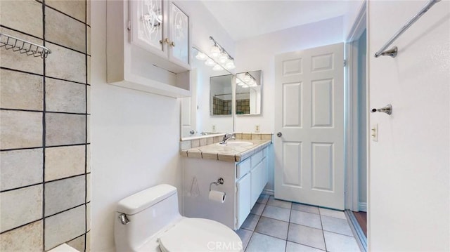 bathroom with vanity, tile patterned flooring, and toilet