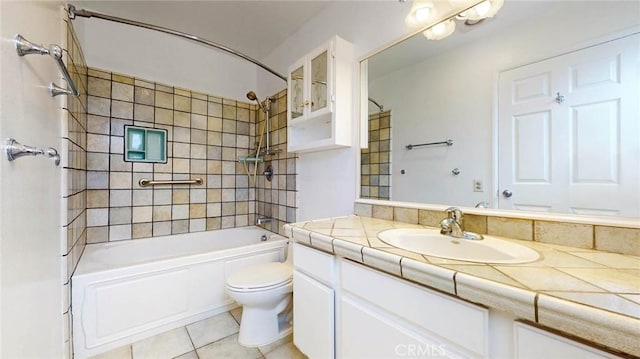 bathroom with tile patterned flooring, shower / tub combination, vanity, and toilet