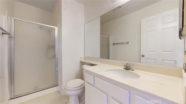 bathroom with a stall shower, vanity, and toilet