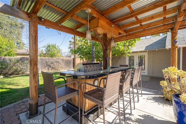 view of patio / terrace with french doors, outdoor wet bar, and fence