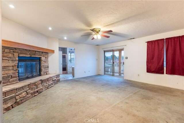 unfurnished living room featuring visible vents, a ceiling fan, a textured ceiling, a fireplace, and recessed lighting