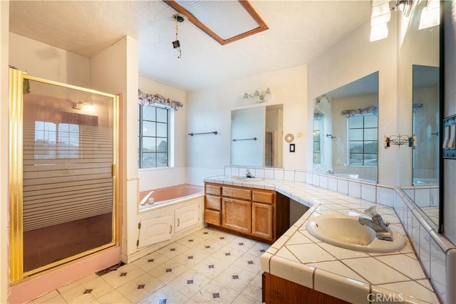 full bathroom with vanity, a shower stall, a bath, and tile patterned floors