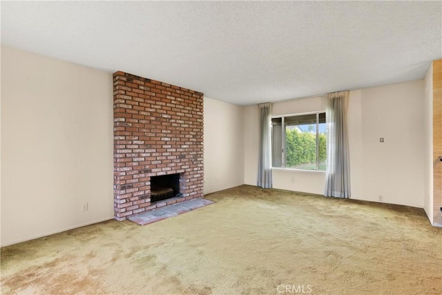 unfurnished living room with carpet, a fireplace, and a textured ceiling