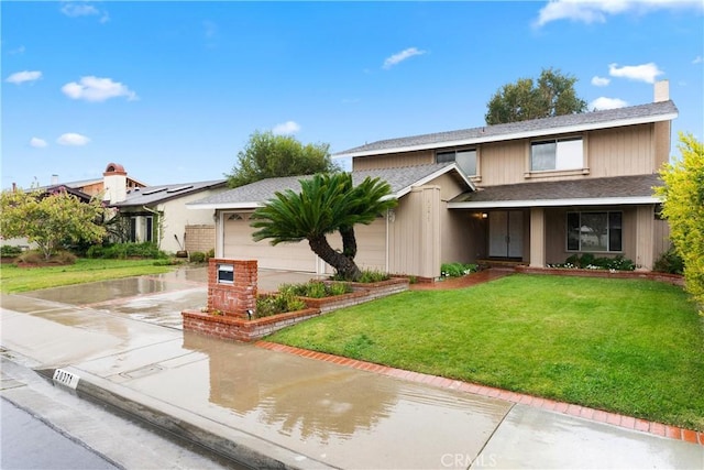 traditional home featuring a shingled roof, concrete driveway, a chimney, an attached garage, and a front lawn