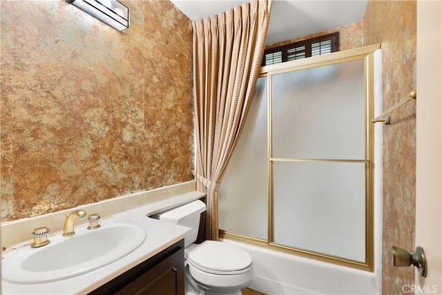 bathroom with enclosed tub / shower combo, toilet, vanity, a wall mounted air conditioner, and wallpapered walls