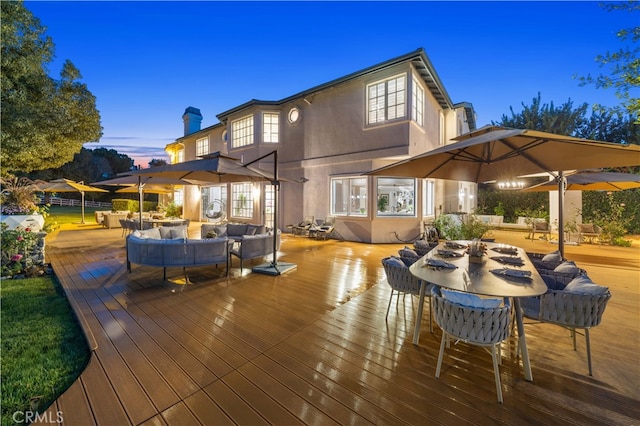 wooden terrace featuring outdoor dining area and an outdoor living space