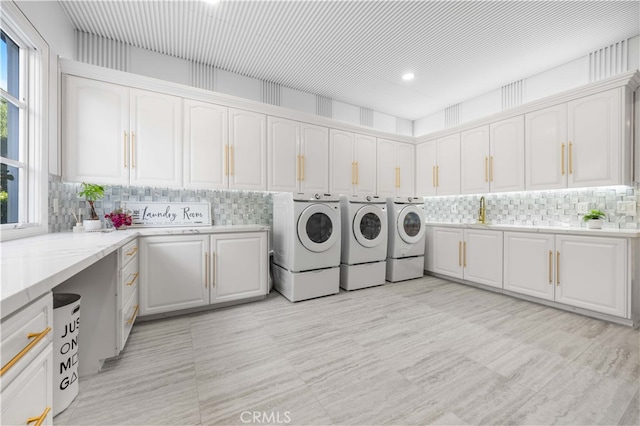 laundry room with cabinet space, washing machine and dryer, and recessed lighting