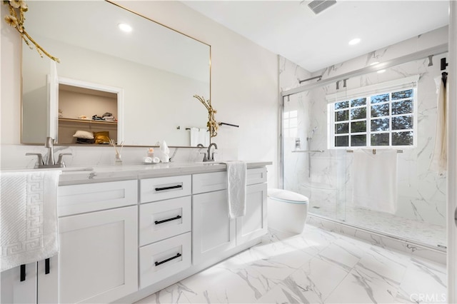 full bath featuring double vanity, a marble finish shower, visible vents, marble finish floor, and a sink