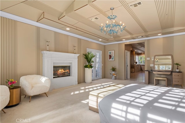 carpeted bedroom with visible vents, a raised ceiling, a glass covered fireplace, crown molding, and a notable chandelier