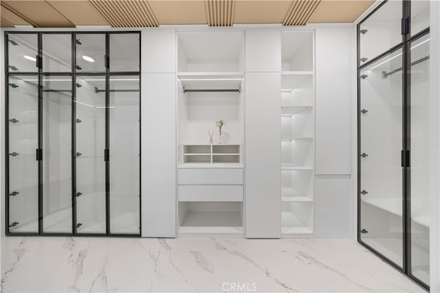 interior space with marble finish floor and a stall shower