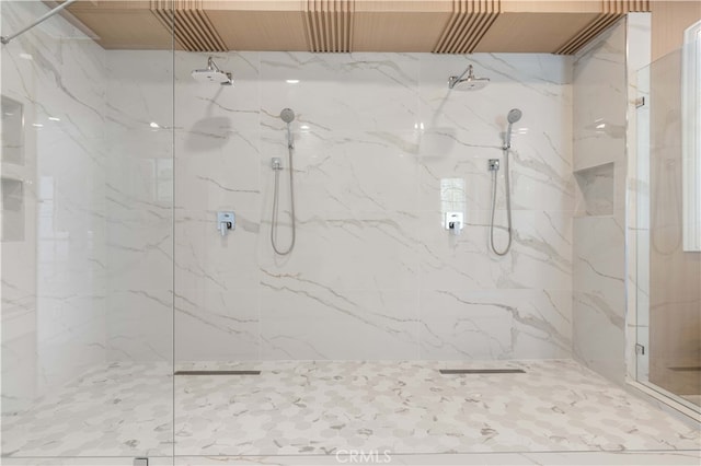 bathroom with a marble finish shower